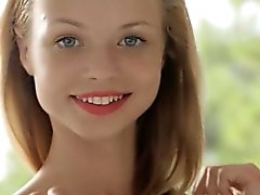 Blonde teen Nomi pulls down her panties and rubs her pussy