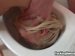 Slut gets a swirlie and a facial in the bathroom