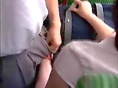 She strokes him and he fingers her on the bus