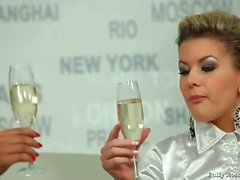 Champagne drinking girls in white satin blouses