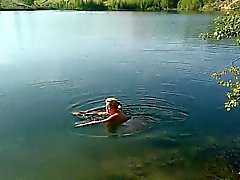 Blonde MILF is swimming naked in a lake and caught on spy c