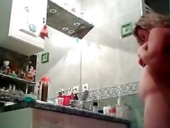 Curvy chick strips naked in bathroom voyeur porn