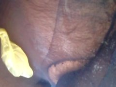 Encased cock in a cum filled condom under double-layer nylon