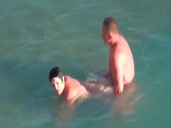 Mature couple boldly fucks in the ocean