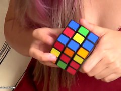 Busty asian teen gives up on solving Rubik's cube and plays